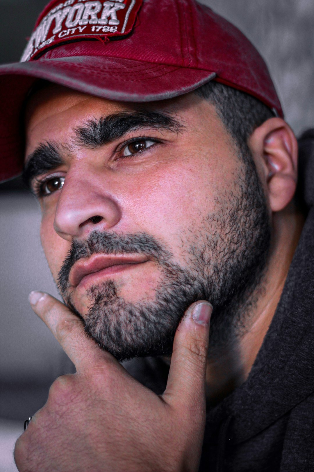 Studio portrait of a Latino man in his thirties with a beard