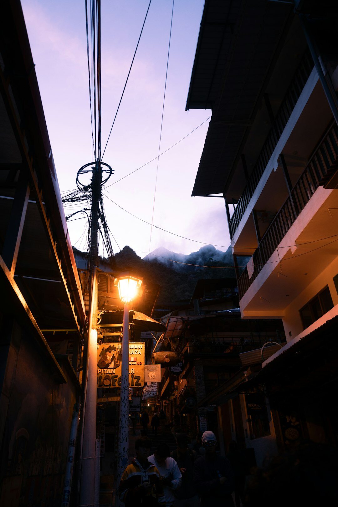Foggy old town street at night with a single streetlamp