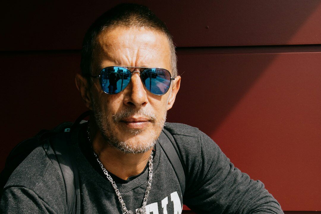 Studio portrait of an older Latino man with glasses